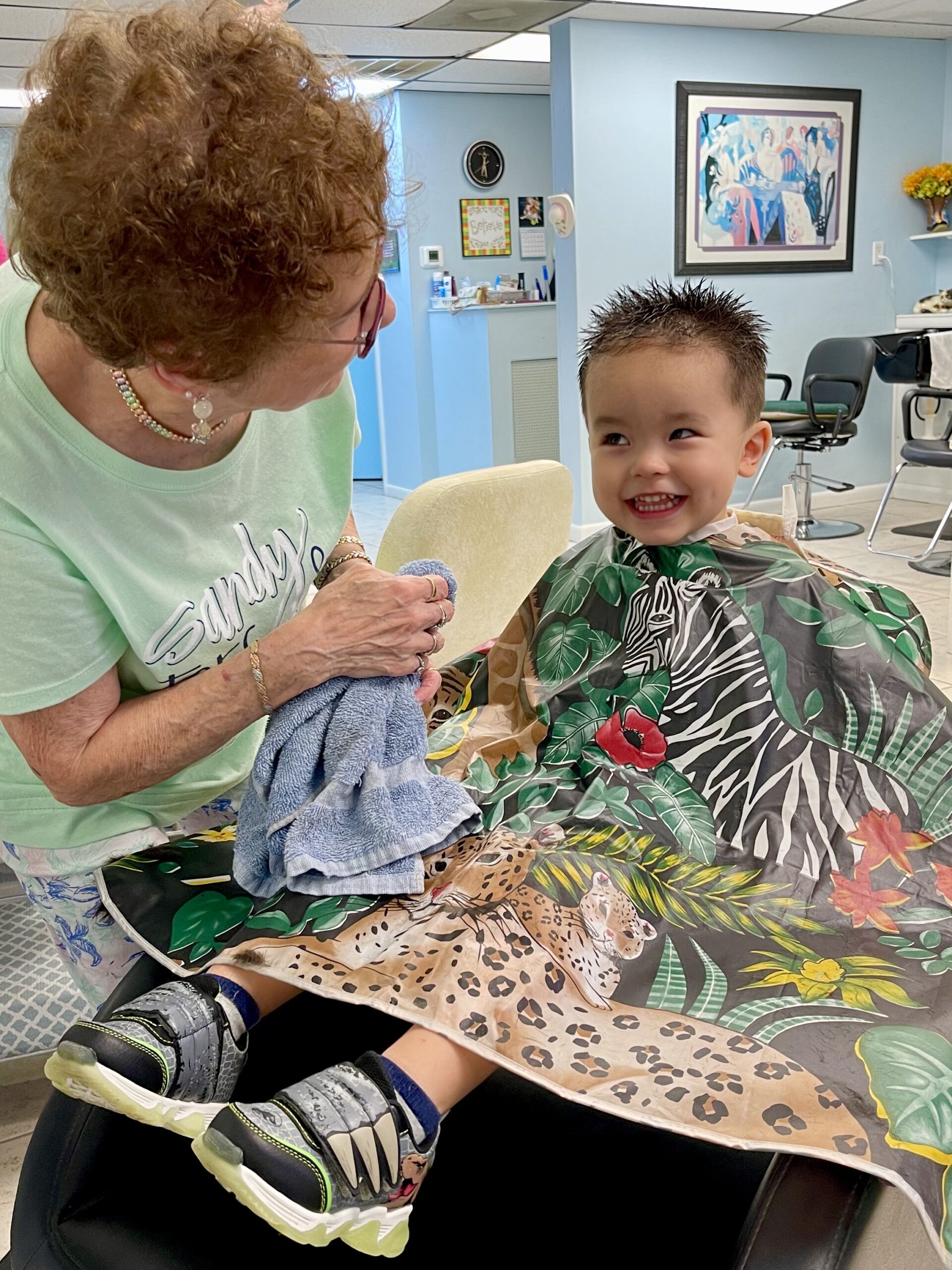 Sandy cutting a toddler's hair